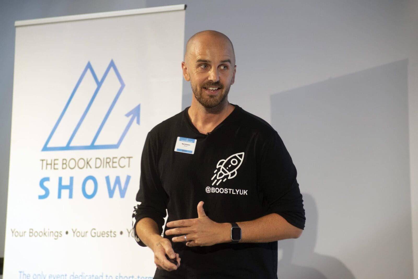 Mark Simpson, founder of Boostly, on stage at the Book Direct Show